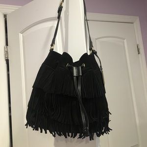 A Vince Camuto black leather fringe shoulder bag.
